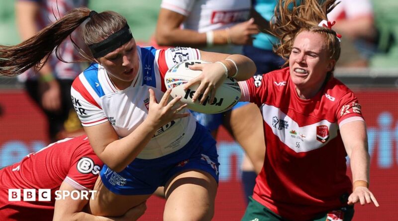 Connie Boyd holds on to the ball as two Wales players look to halt her progress