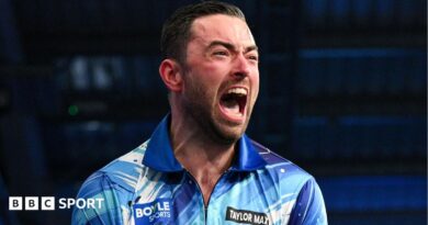 Luke Humphries celebrates beating Gerwyn Price to win the World Grand Prix